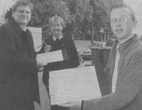 Signing up, Mrs Winnie Linn helps push forward the campaign to bring broadband to Lhanbryde and other smaller communities as Moray MP Angus Robertson gathers signatures in the street, helped by Elgin Academy pupil Garry Inglis was on work experience in Mr Robertson's constituency office.