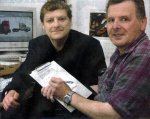 [photo]MP Angus Robertson, left, hands over a petition about broadband for Dufftown resident Leslie Craib to sign.